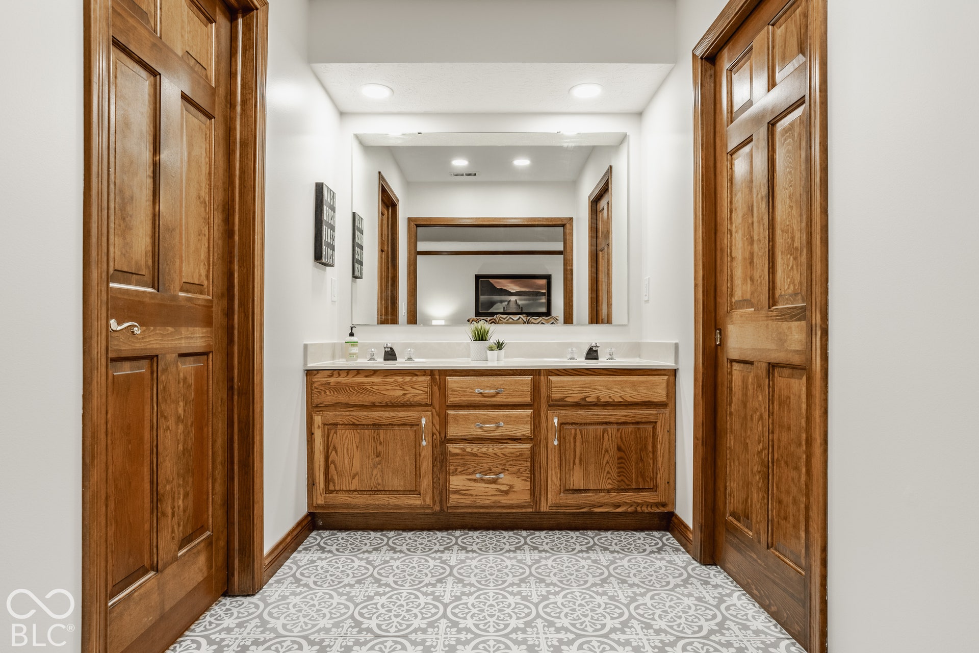 Behind two wood pocket doors, a massive ensuite with dual vanity and doors leading to the closet and bathroom.