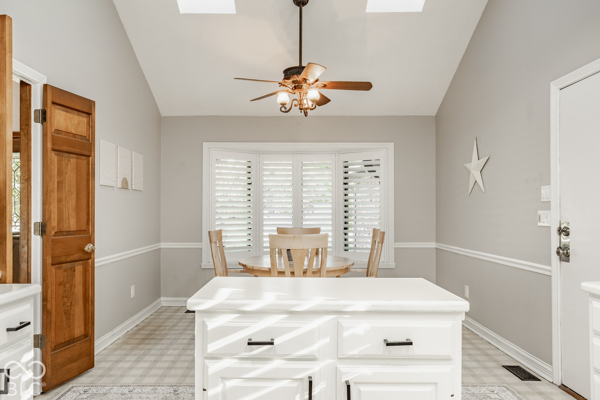 Eat in kitchen with center island, vaulted ceiling with new skylights ceiling fan and plantation shutters.