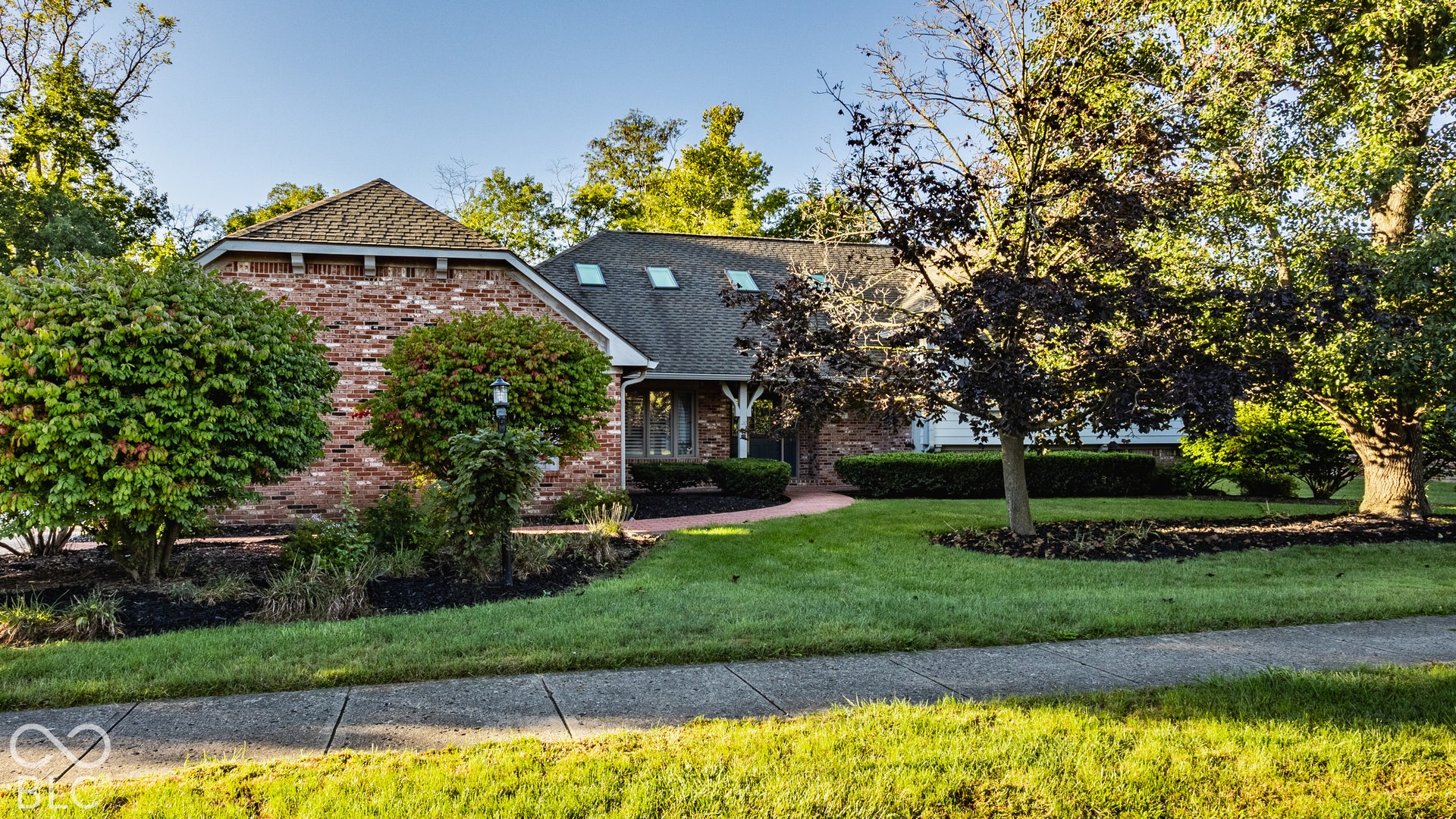 Brick home in Pine Ridge Estates with mature landscaping, and siding with a life time warranty