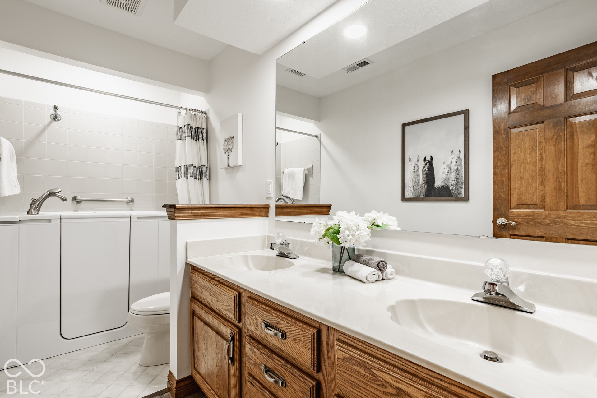Upstairs hall bathroom equipped with step in senior tub and grab bars.