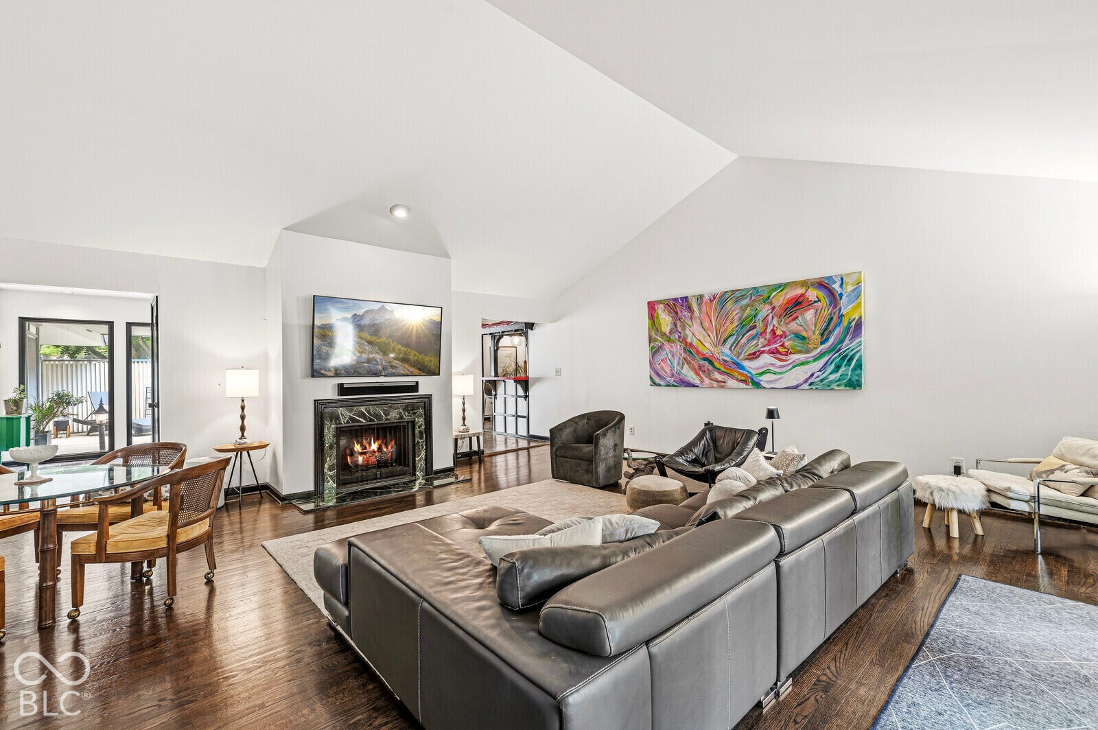 7622 Silverpine Court, Indianapolis, IN 46250 Spacious, light-filled gathering space features a pitched ceiling, expansive west-facing glass doors and cozy gas fireplace. Direct access to deck and courtyard.