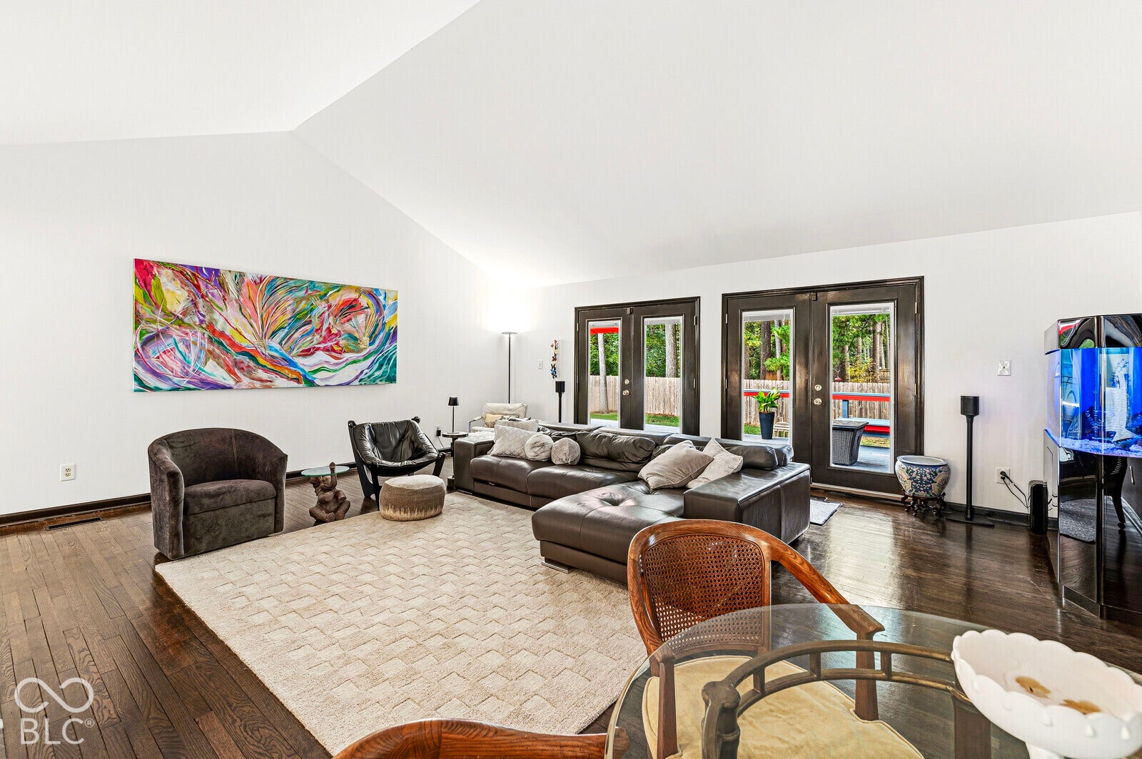 7622 Silverpine Court, Indianapolis, IN 46250 Spacious, light-filled gathering space features a pitched ceiling, expansive west-facing glass doors and cozy gas fireplace. Direct access to deck and courtyard.