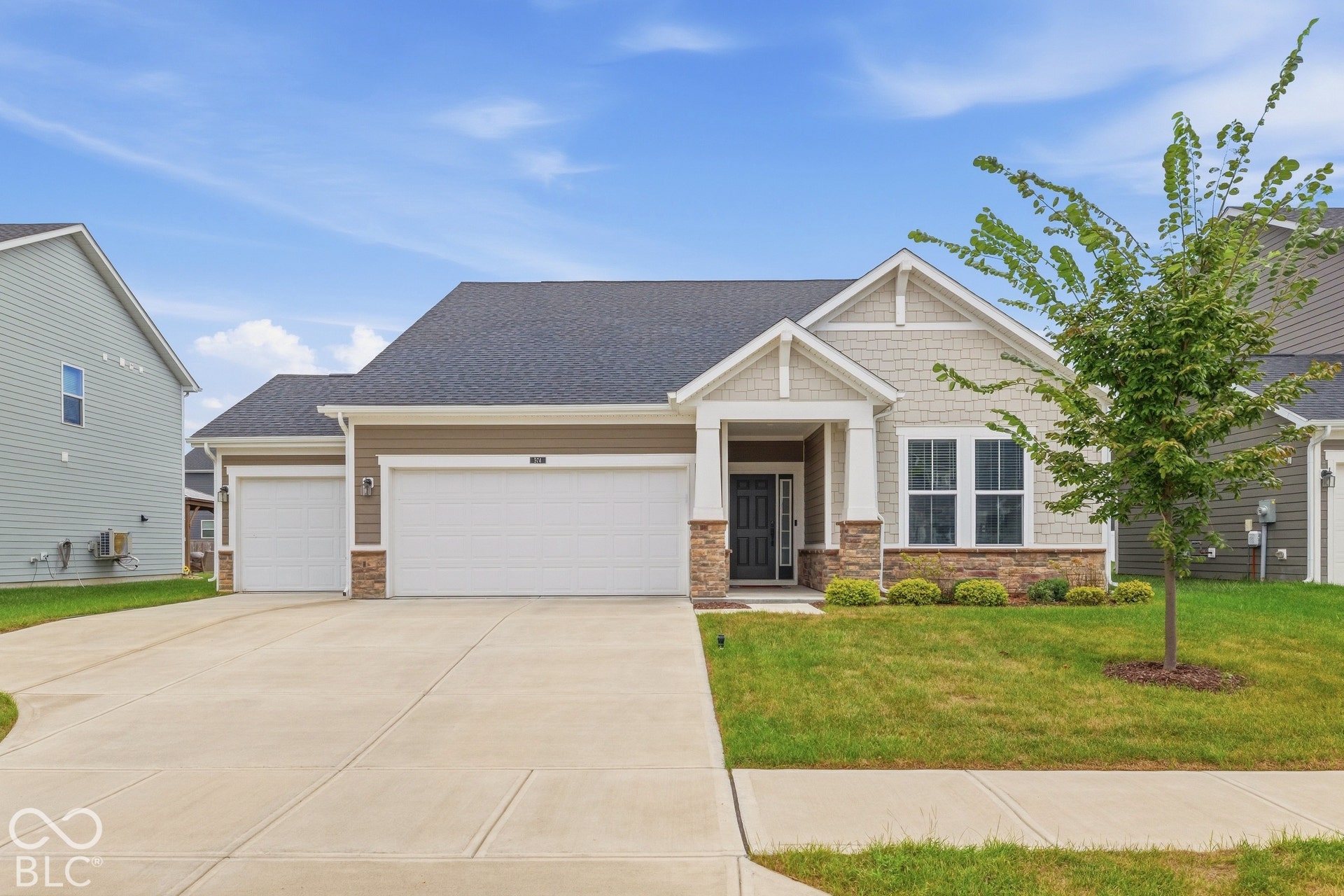 Front of home - driveway and 3 car garage