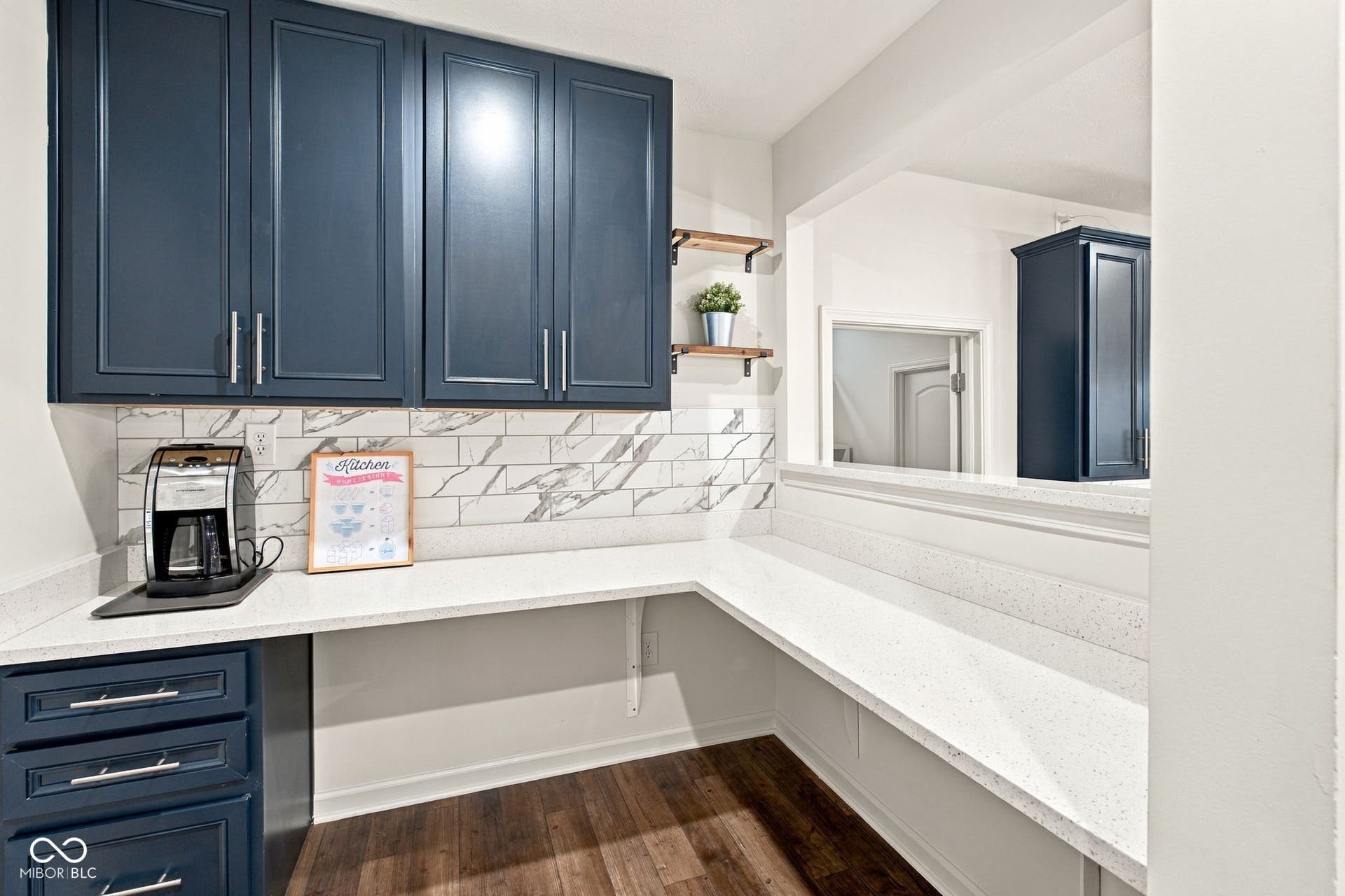 Planning Room w/ cabinets, white stone-finish countertops, tile backsplash, LVP flooring, and open shelving