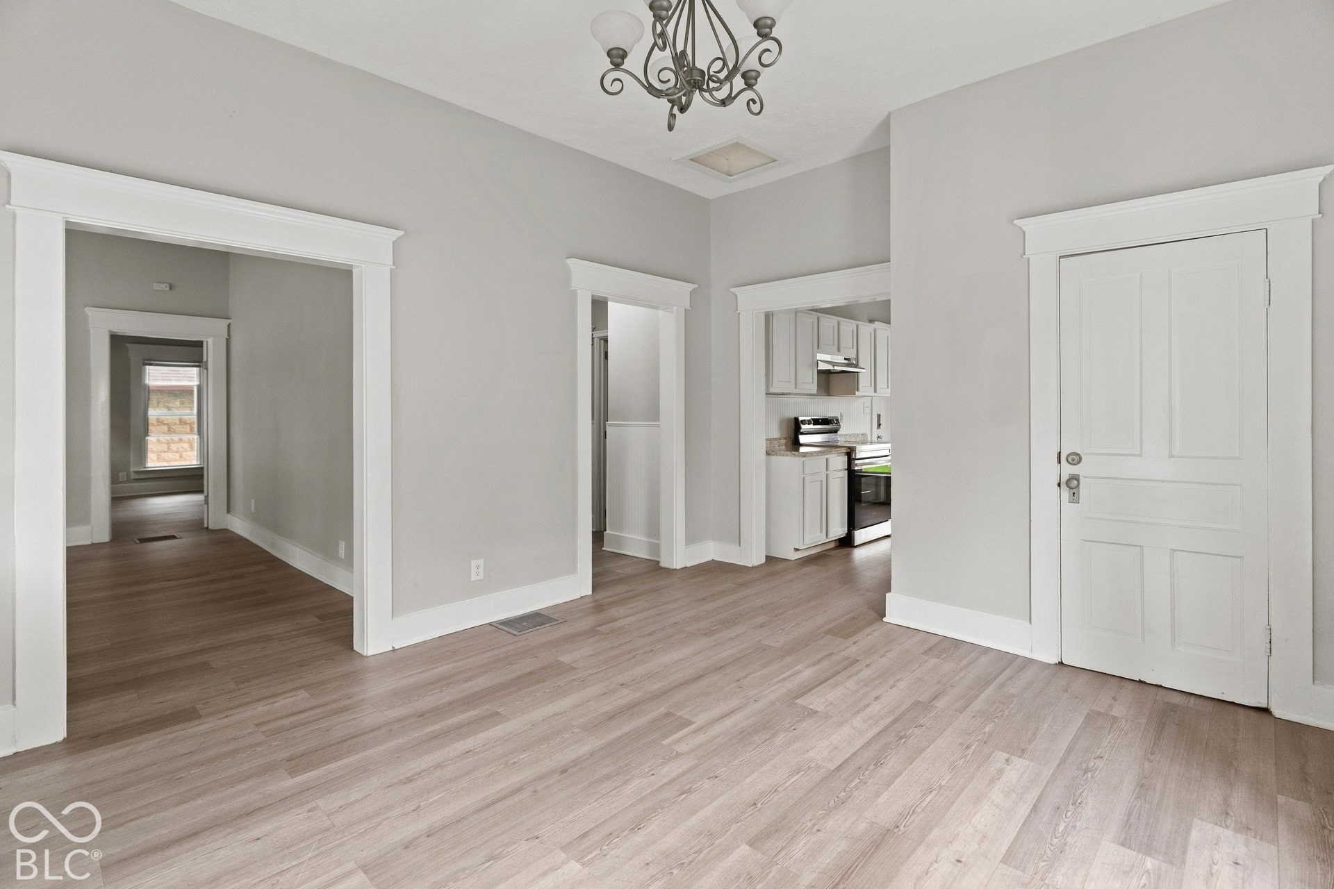 Dining room is next to living room, laundry area, and kitchen. Door leads to basement.