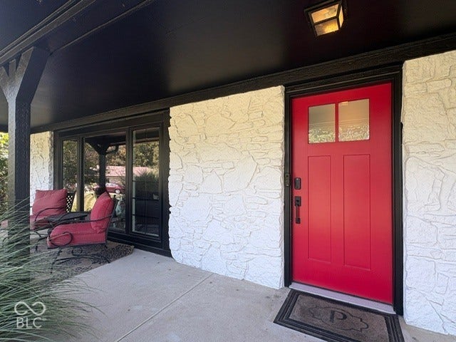 Red paneled entry door with clear glass panels