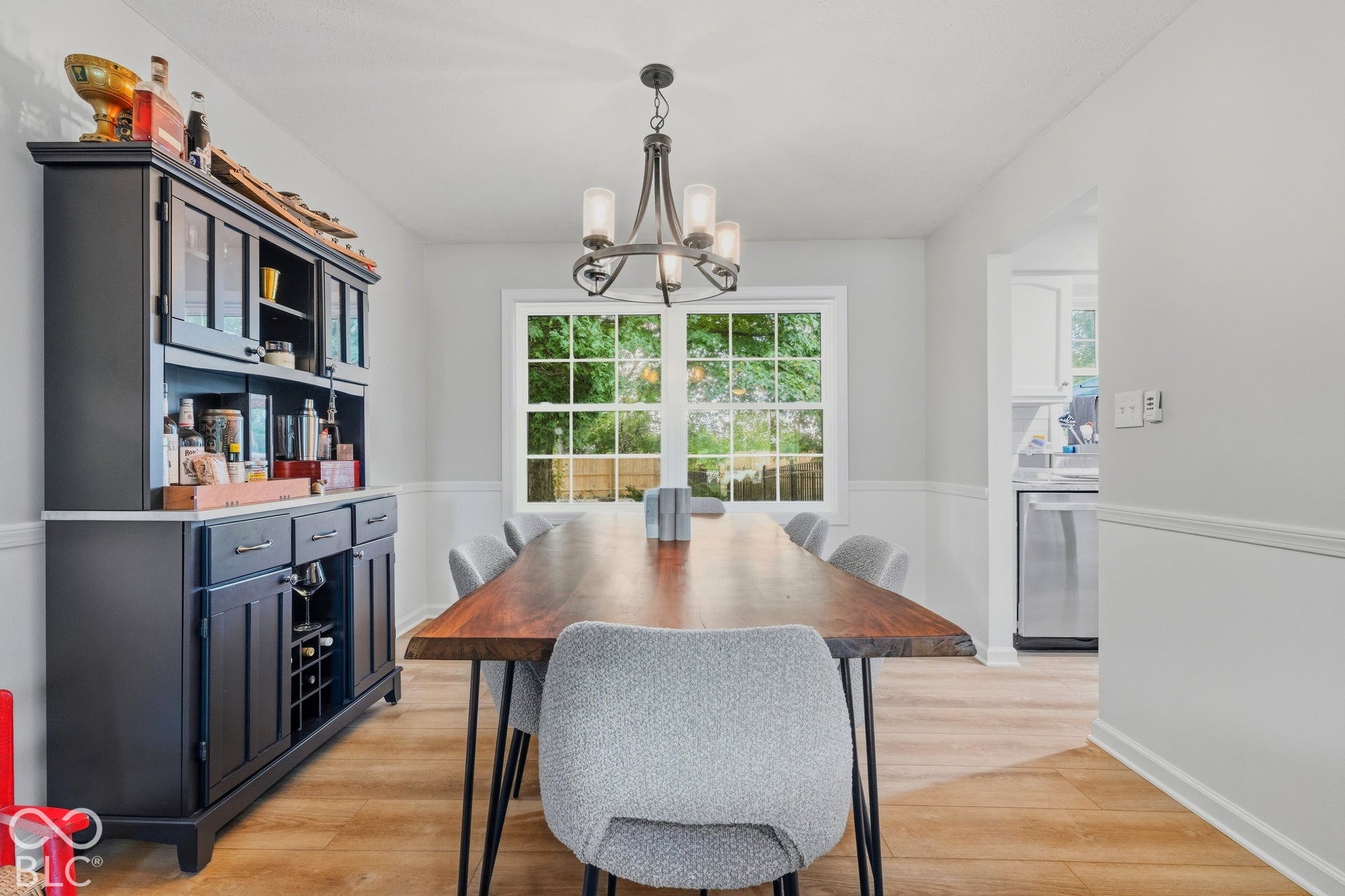 Wood-finish flooring with white wall paneling