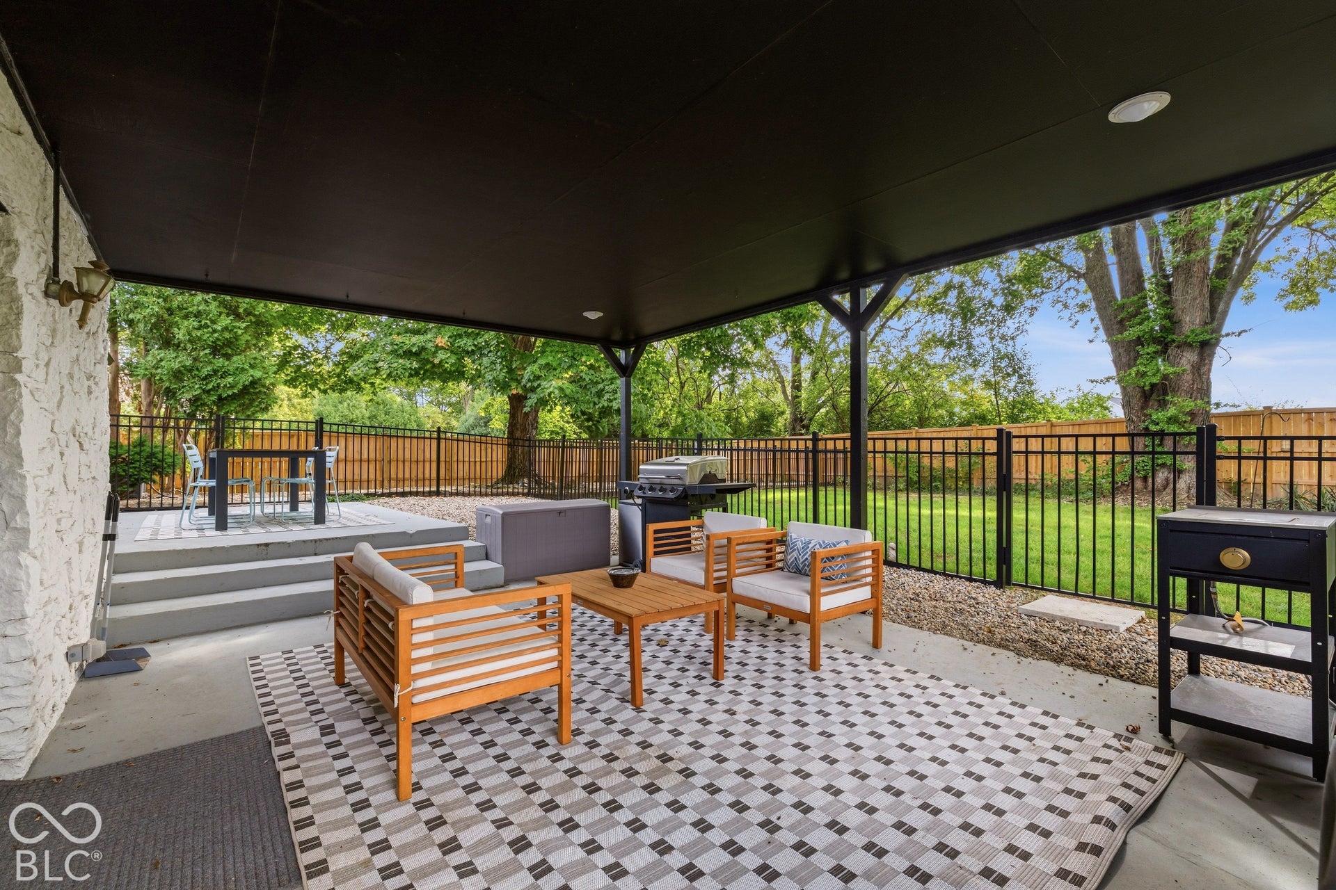 Covered patio with recessed lighting, concrete flooring, and a stone-clad exterior wall