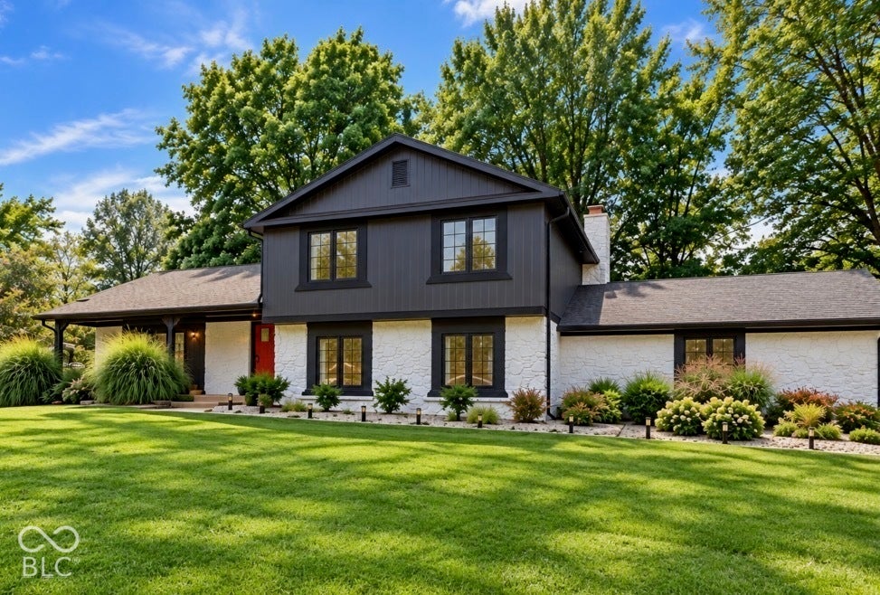 Two-story exterior with dark siding and white textured lower level
