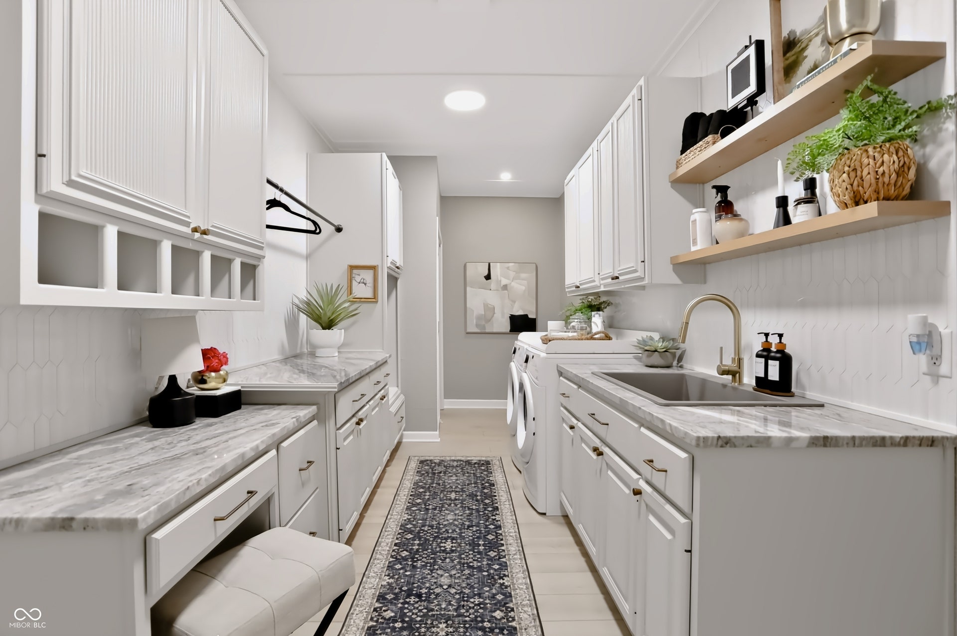 7405 Rooses Drive, Indianapolis, IN 46217 Laundry room featuring shaker-style cabinetry, a built-in sink with a gooseneck faucet, light-toned countertops, and open shelving
