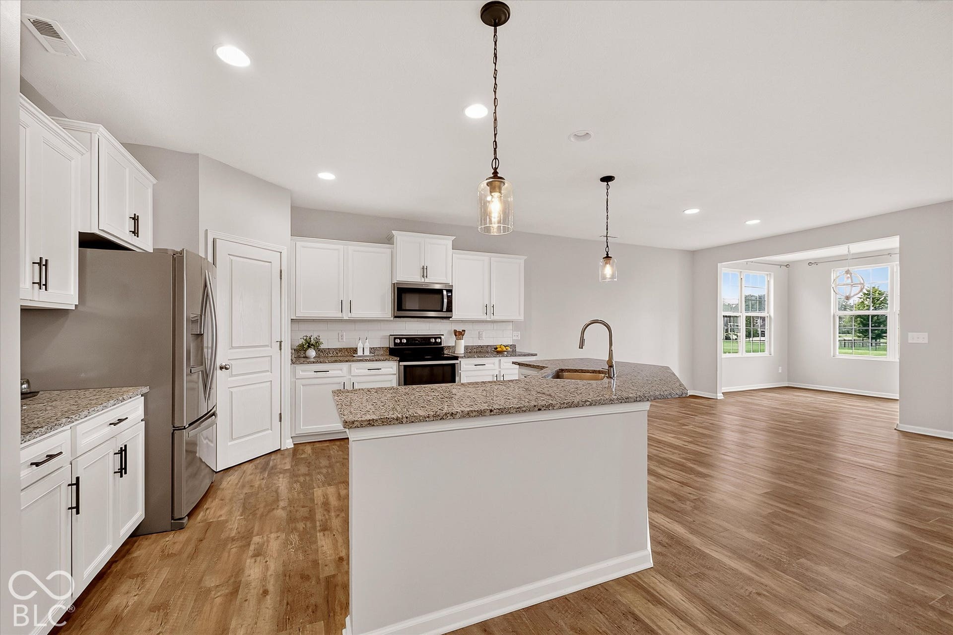 Kitchen open to living space and sunroom