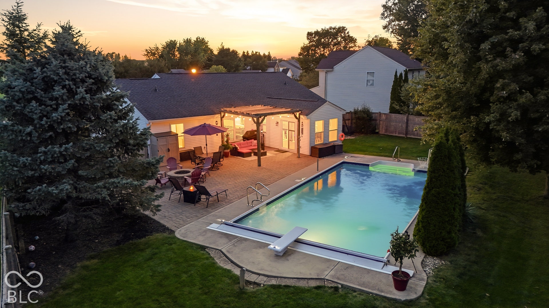 Expansive backyard featuring an in-ground swimming pool, an attached hot tub, a paver patio, and a pergola