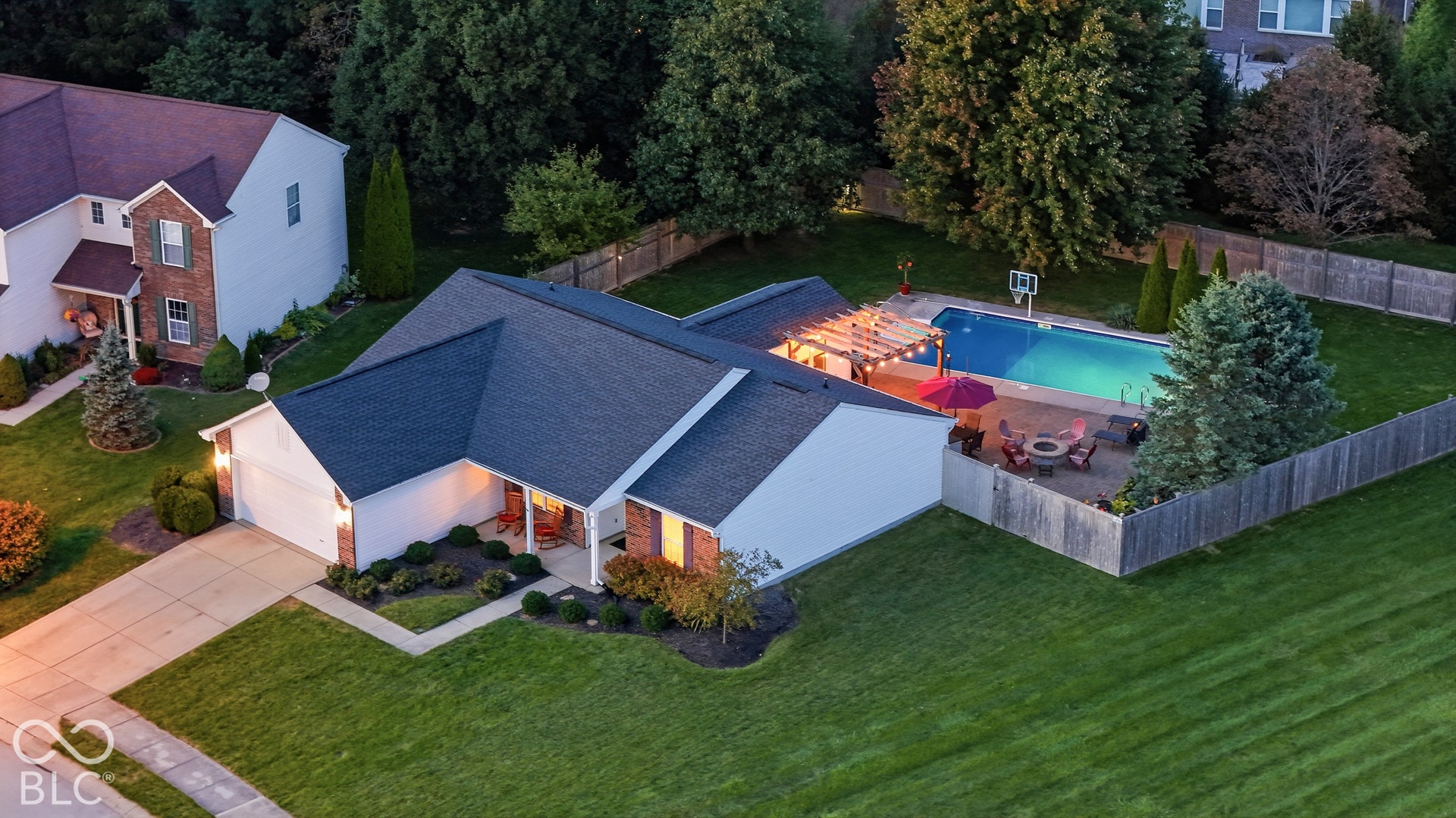 Fenced backyard with an in-ground swimming pool, adjacent patio, and a pergola structure