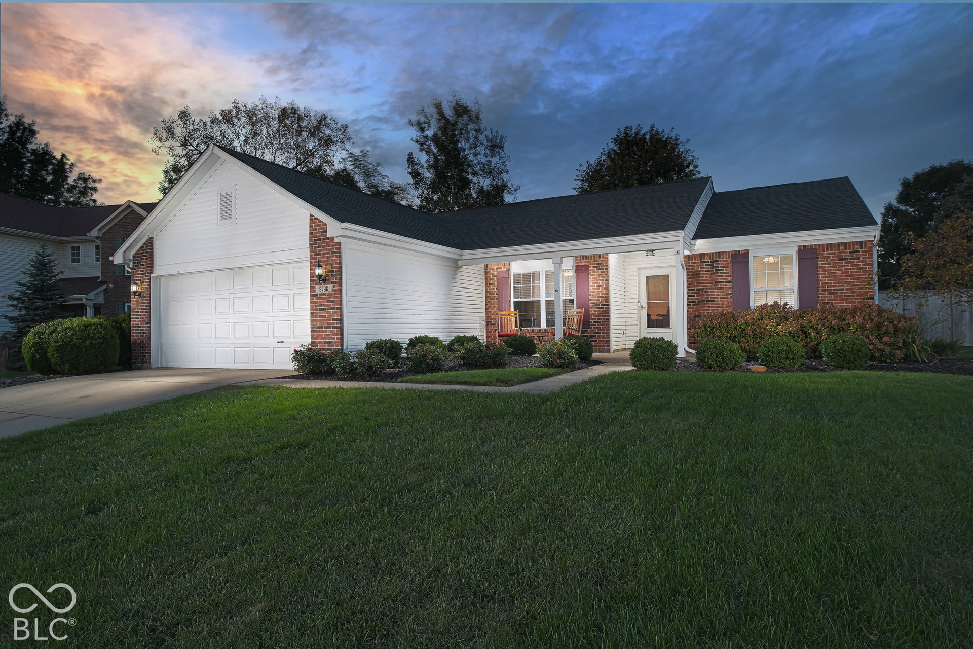 Brick and siding exterior with a dark-pitched roof