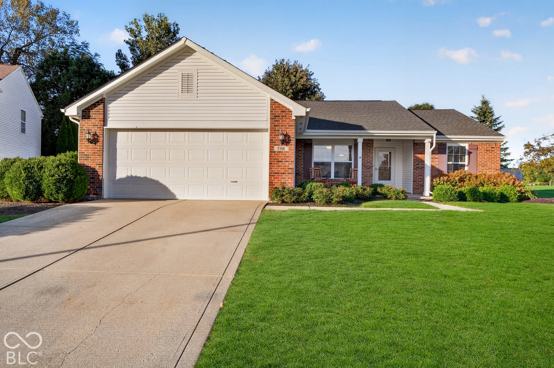 Brick and siding exterior with a dark shingle roof