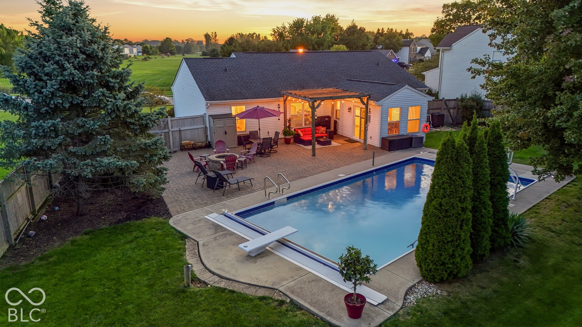 Backyard featuring a swimming pool, concrete pool deck, and a paver patio