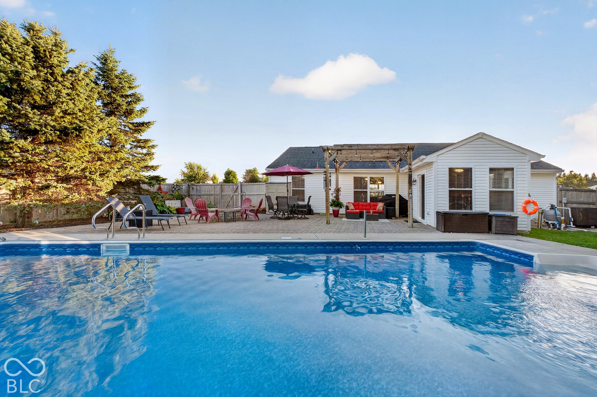 Expansive in-ground swimming pool with surrounding concrete decking