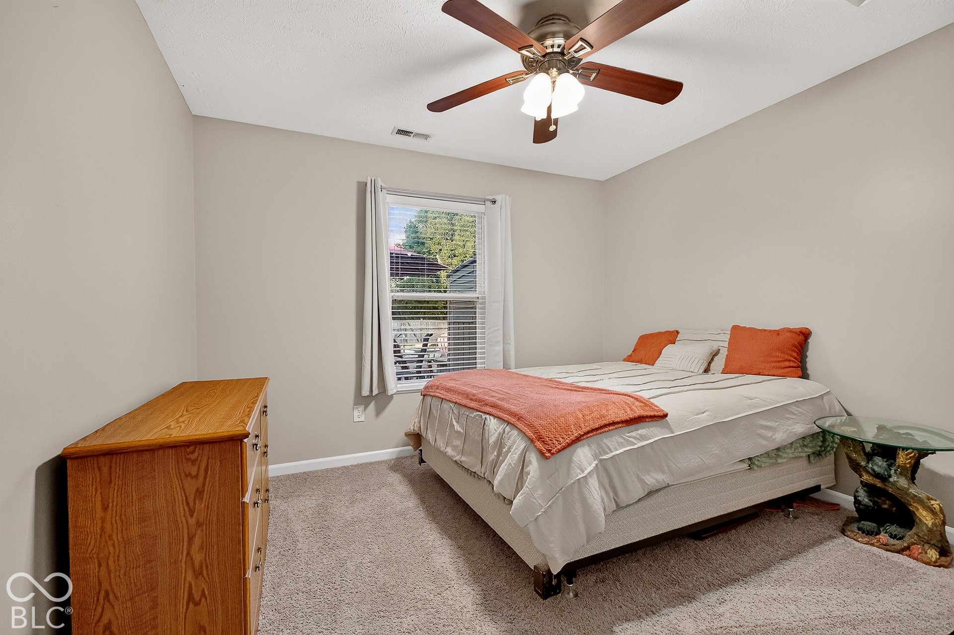 Recessed window with blinds, ceiling fan with integrated lighting, and neutral wall paint
