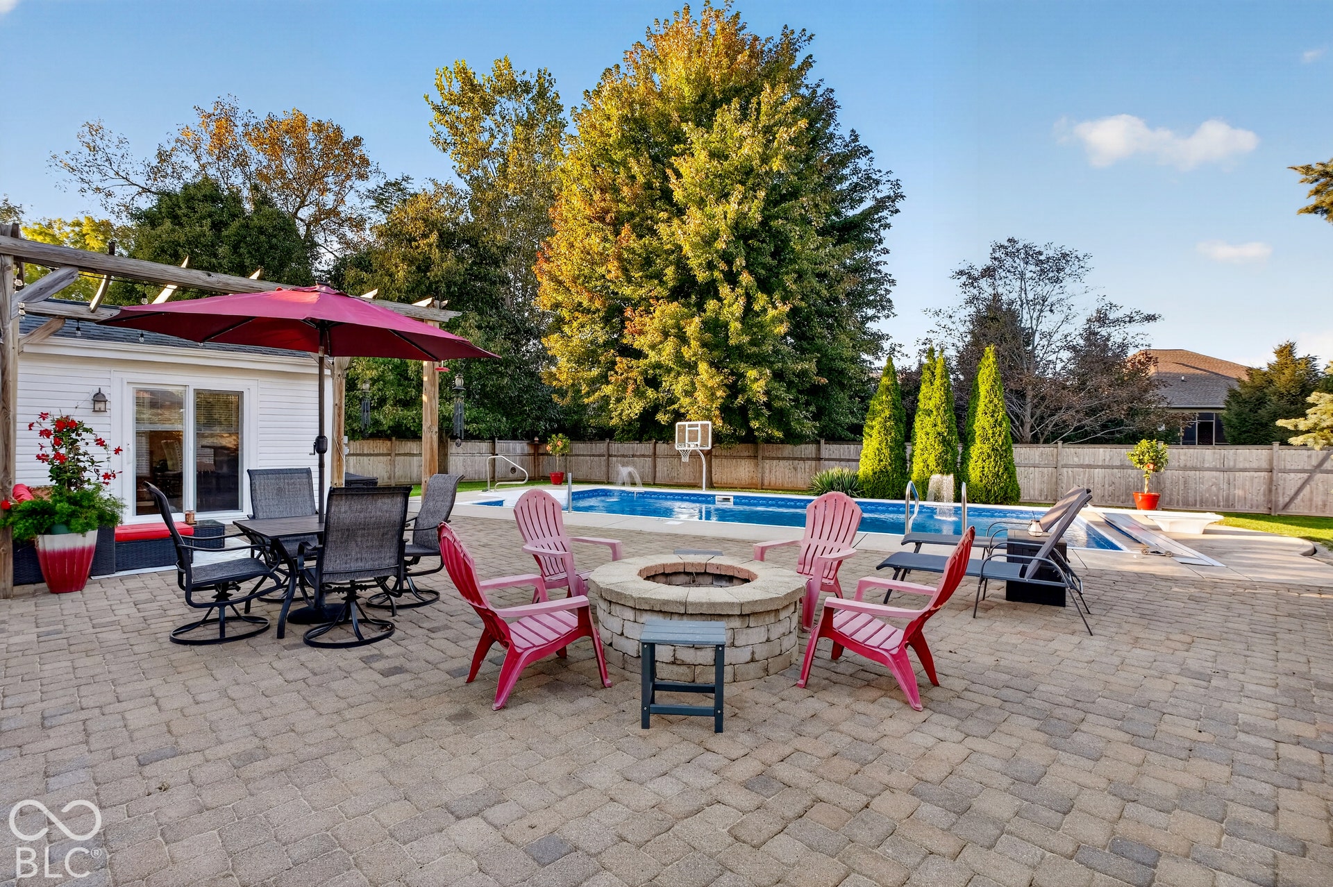 Paver patio leading to an in-ground swimming pool