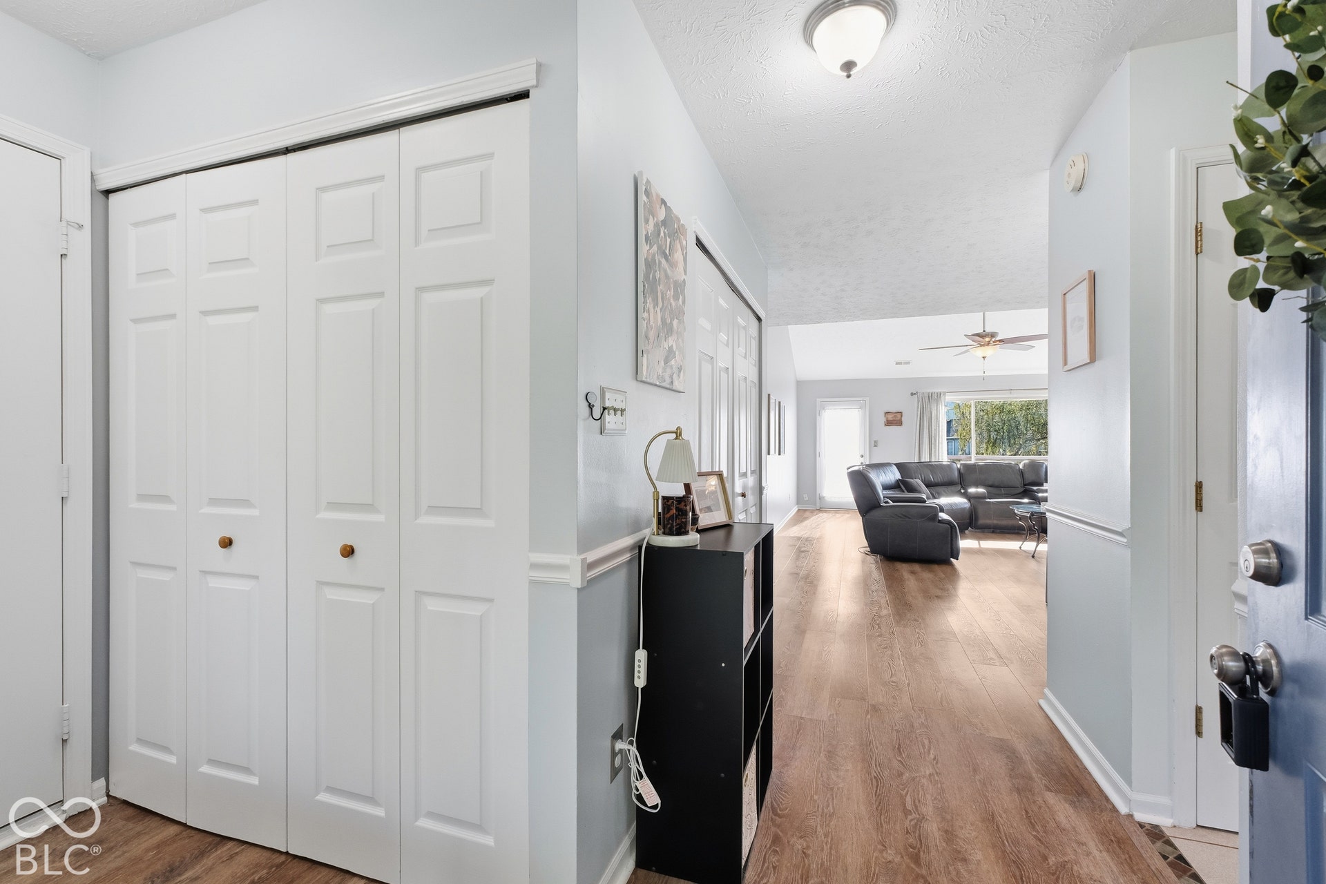 Wood-finish flooring throughout, bright interior paint, and paneled bifold doors