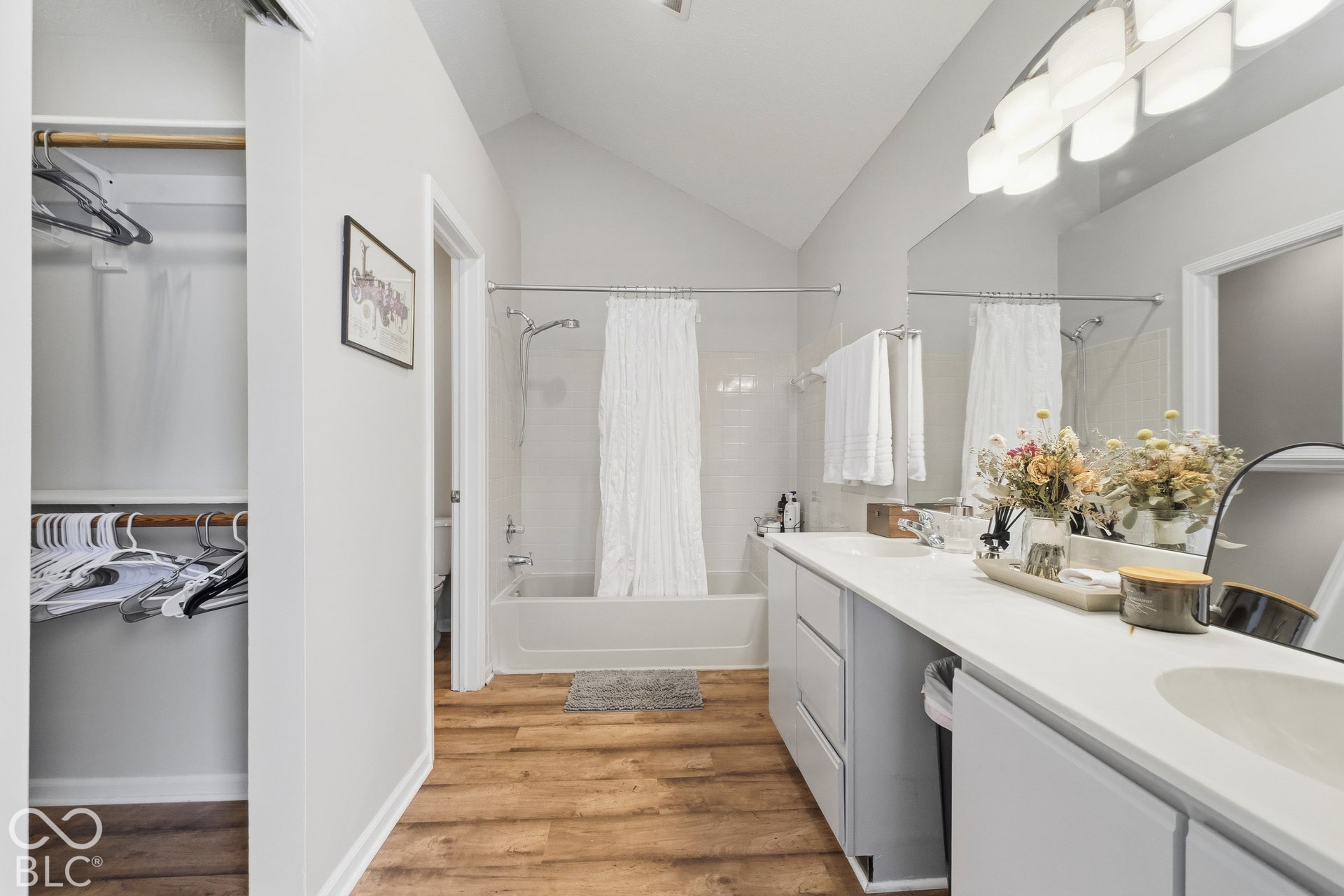 Dual vanity with undermount sinks, white countertop, and light gray cabinetry