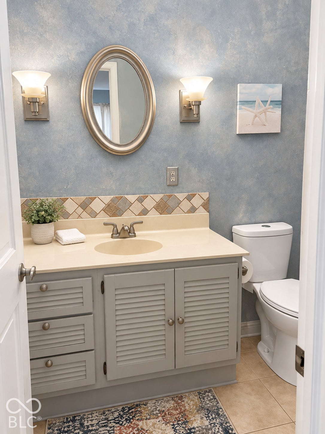 Vanity with a built-in sink, louvered cabinet doors, and a tiled backsplash
