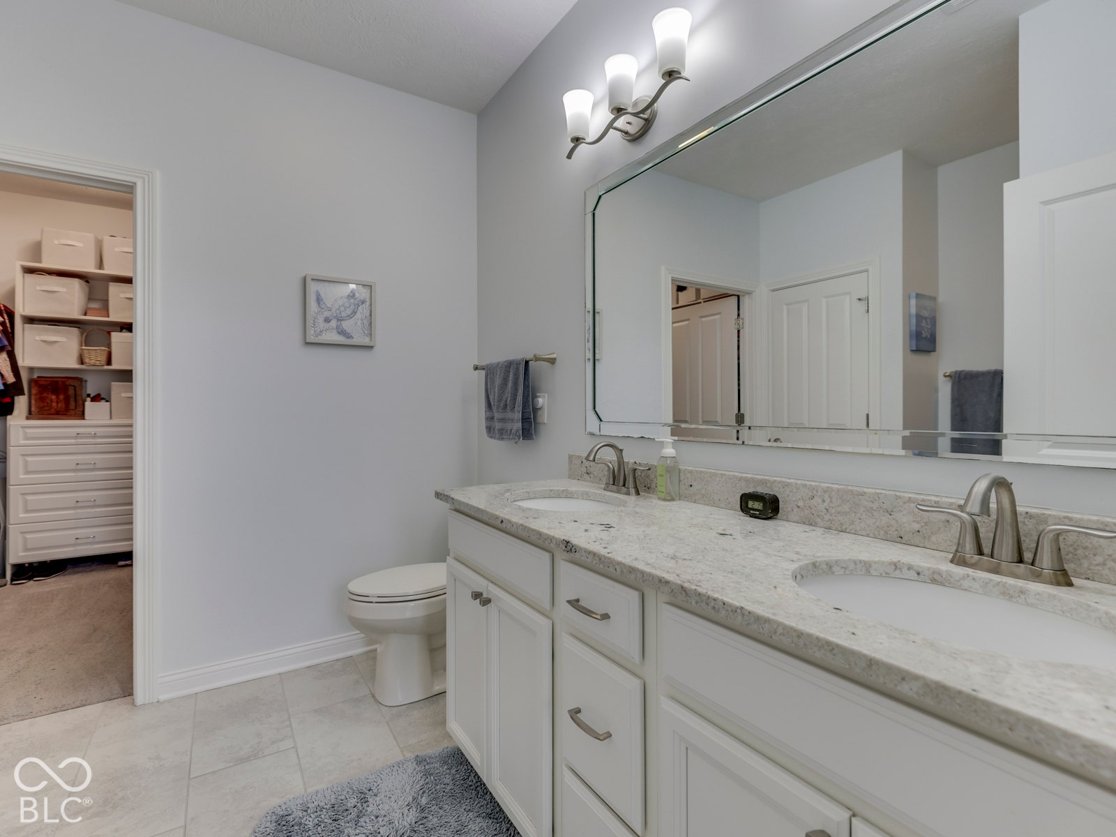 Primary bath has dual sinks, huge custom closet
