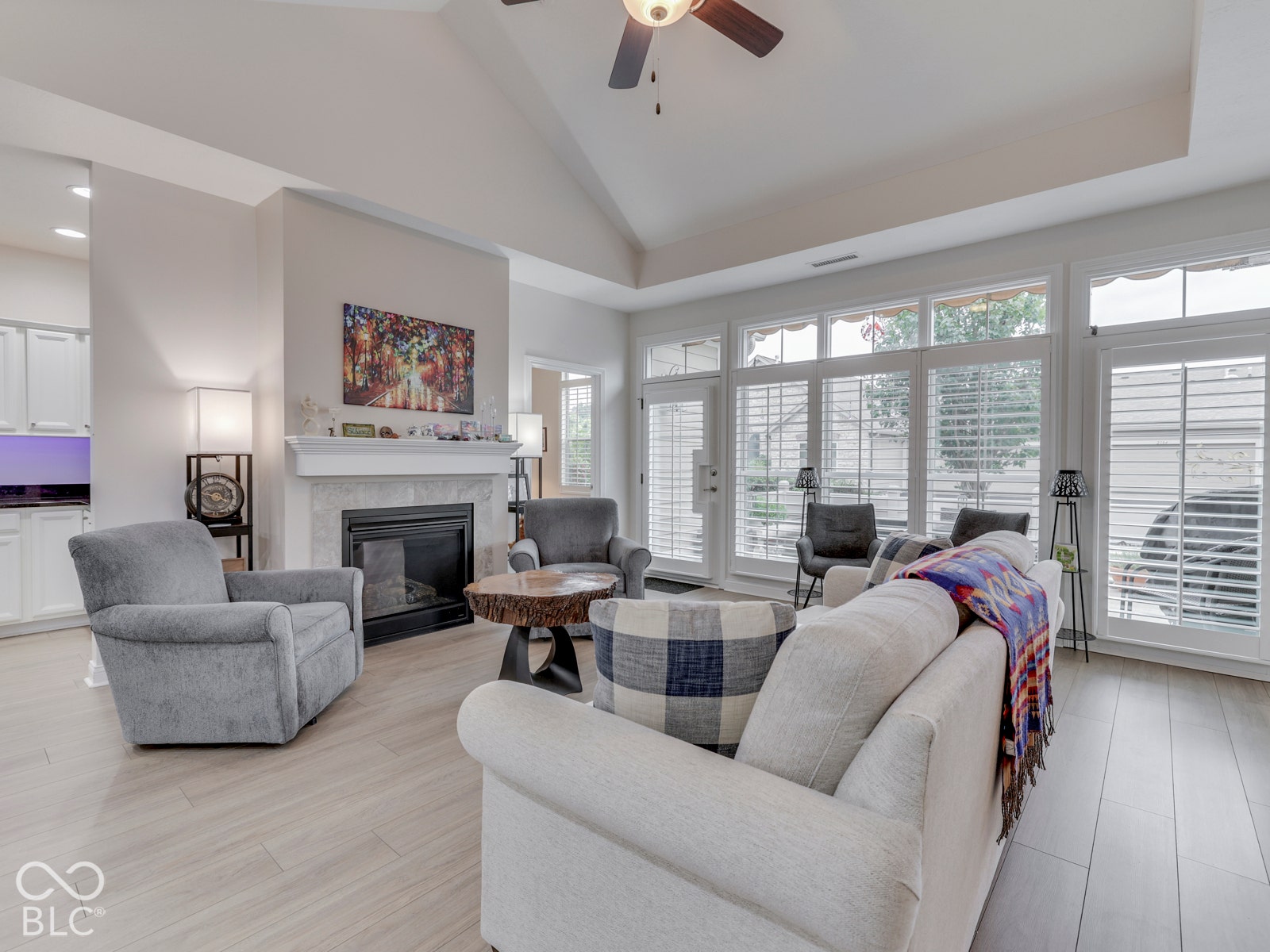 Family room cozies up to a gas log fireplace - so much natural light!