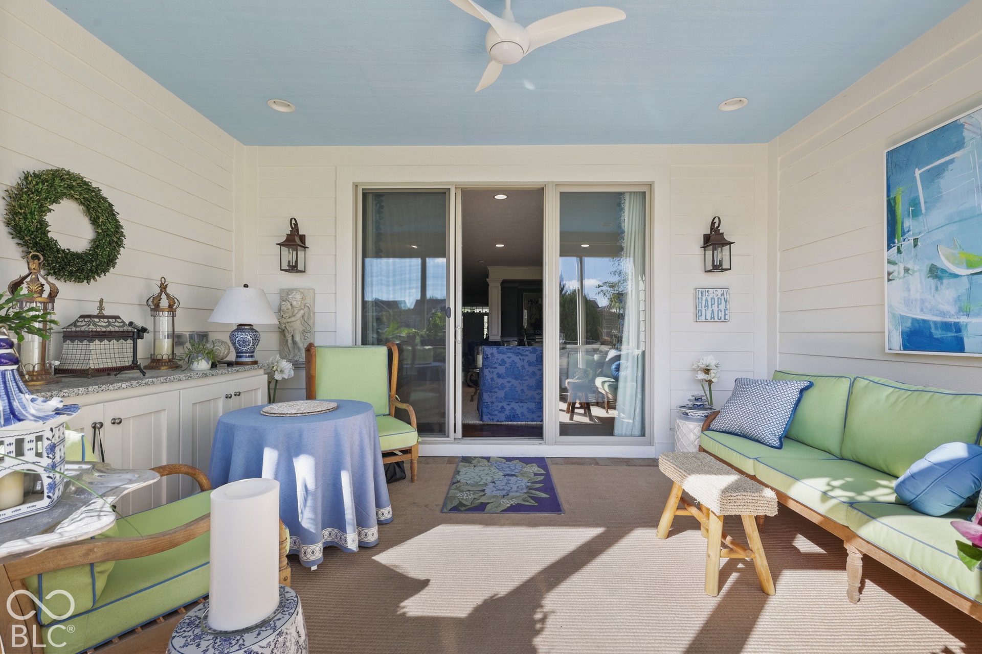 Virtually Altered - Covered patio with a light blue ceiling, recessed lighting, and a ceiling fan