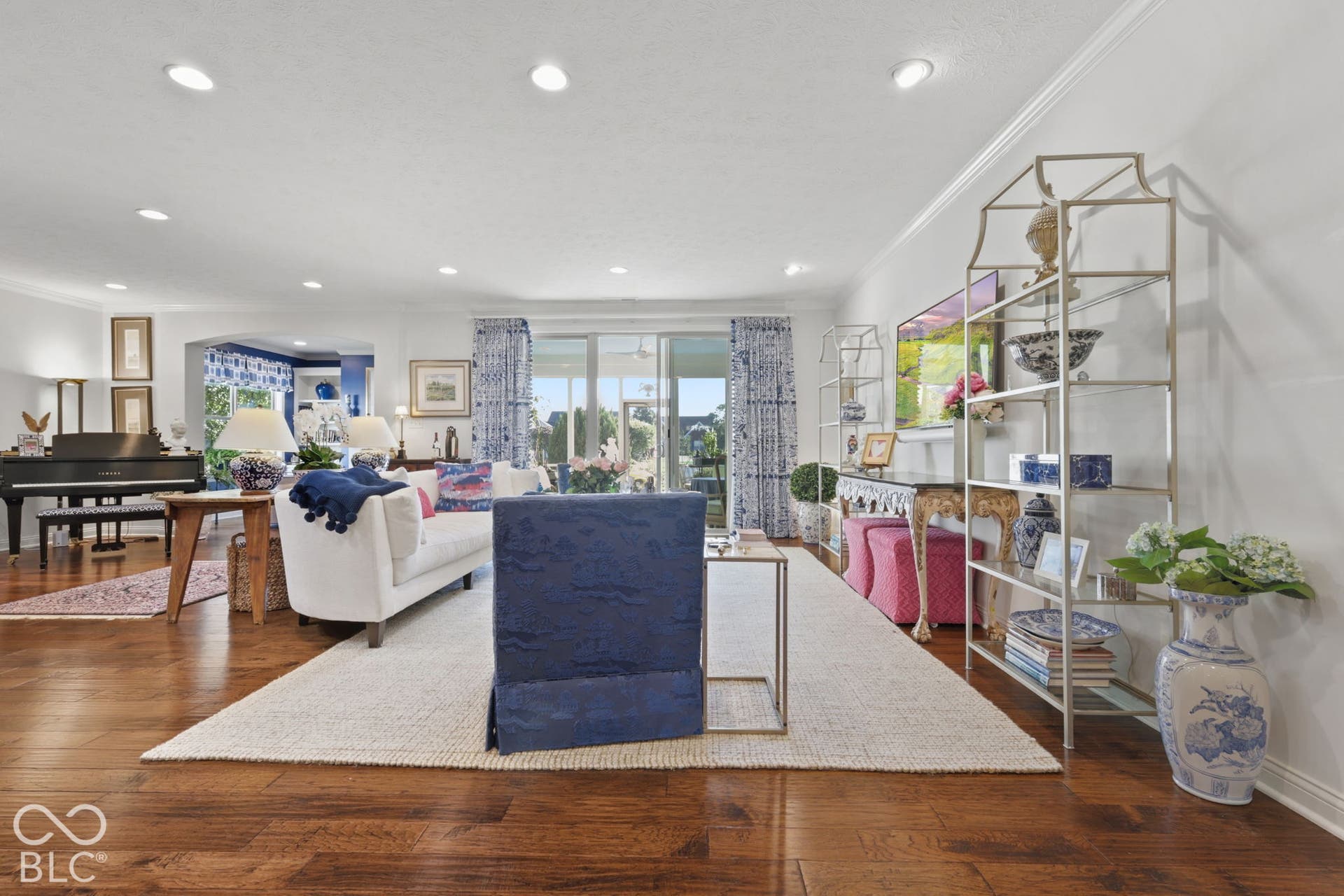 Hardwood flooring throughout, recessed lighting, and crown molding