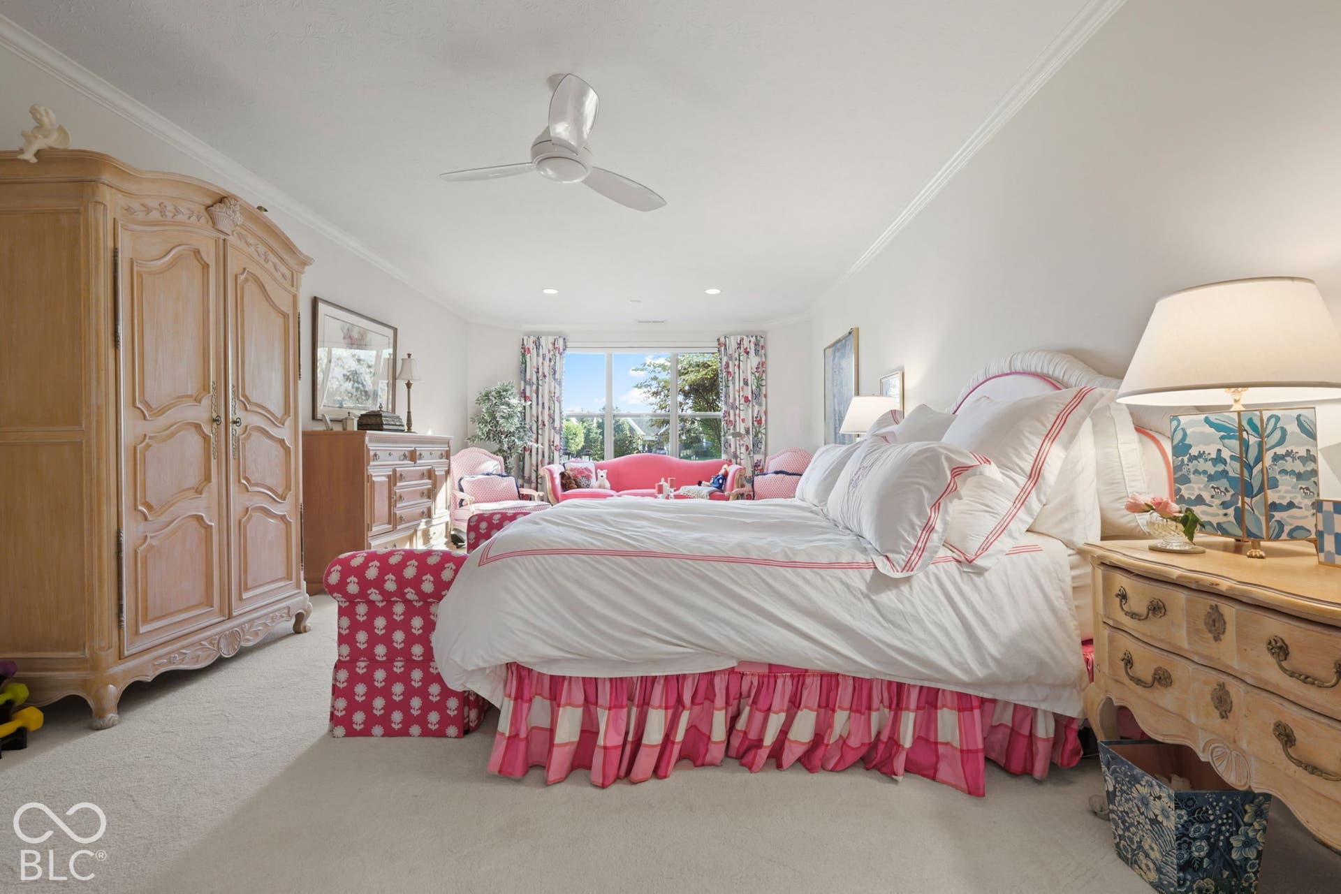 Recessed lighting, crown molding, ceiling fan, and large windows with privacy drapery