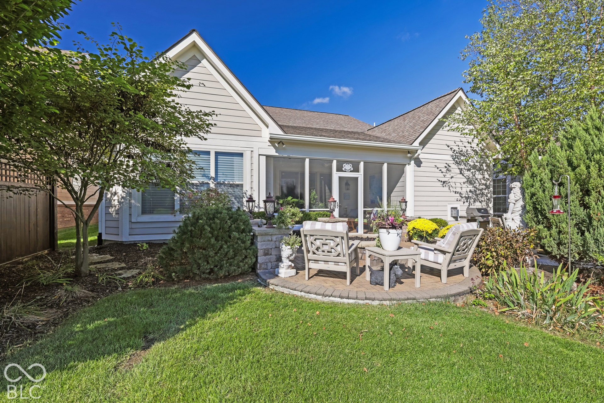 Virtually Altered - Screened-in porch, paver patio, siding exterior, gabled roofline, and mature landscaping