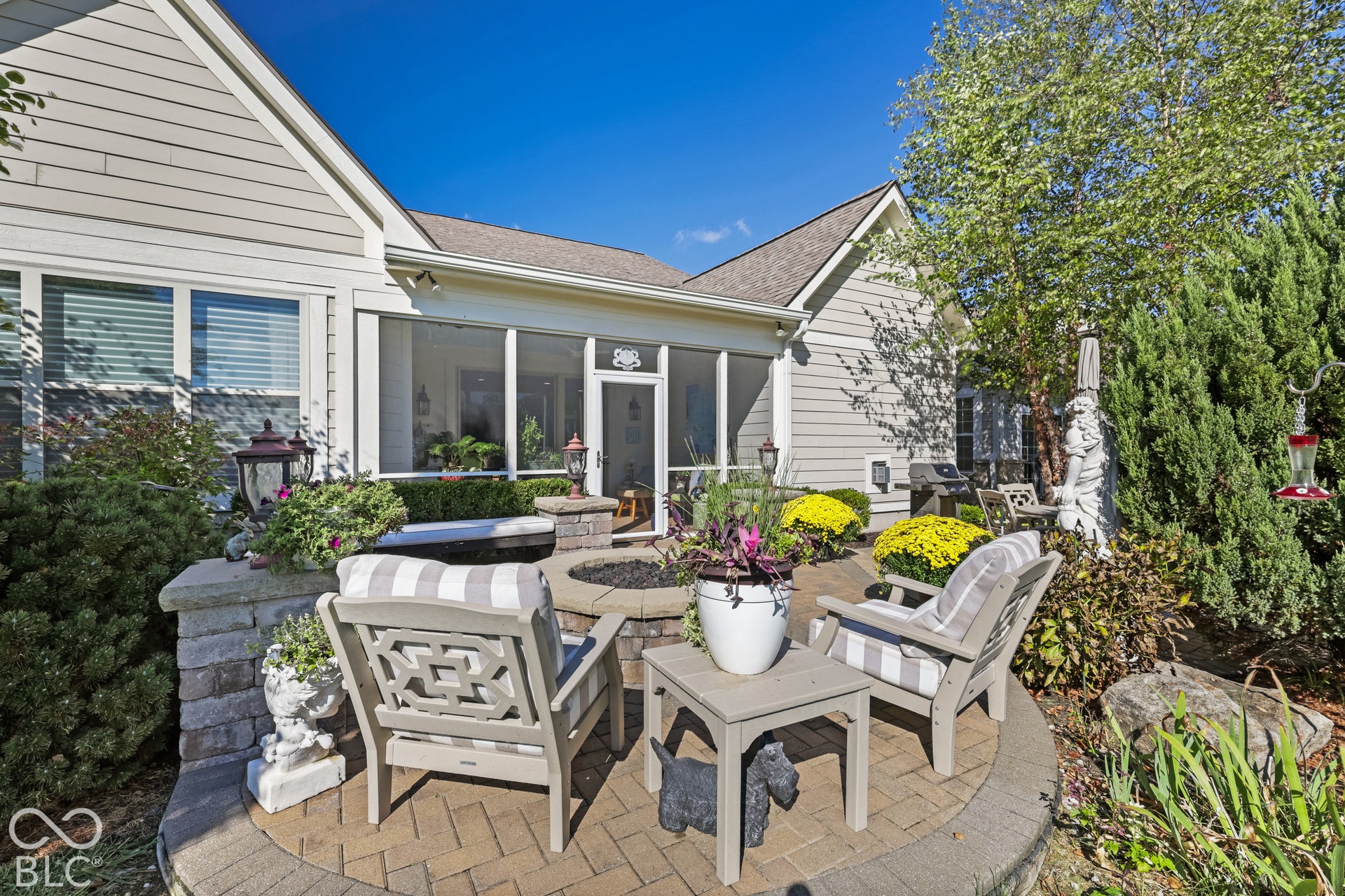 Virtually Altered - Brick paver patio featuring a built-in fire pit with stone surround