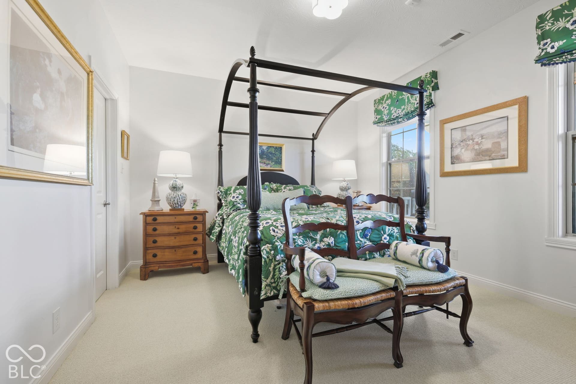 Carpeted flooring, vaulted ceiling, and dual windows with decorative valances