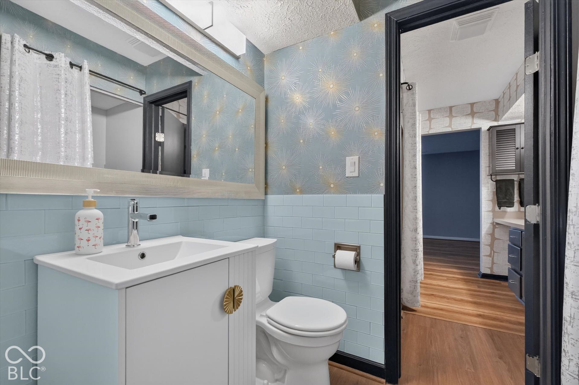 Vanity with integrated sink, chrome faucet, and white cabinetry