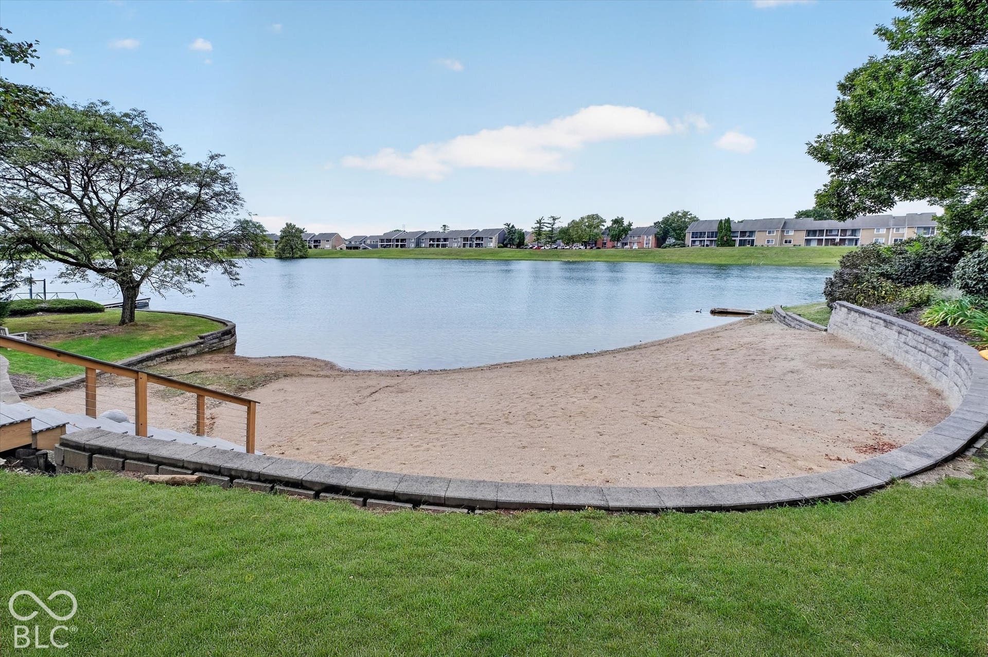 Private sandy beach with retaining wall and lake access
