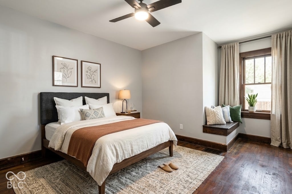 Virtually Altered - Hardwood flooring with a built-in window seat, ceiling fan with integrated lighting, and window with wood-finish trim