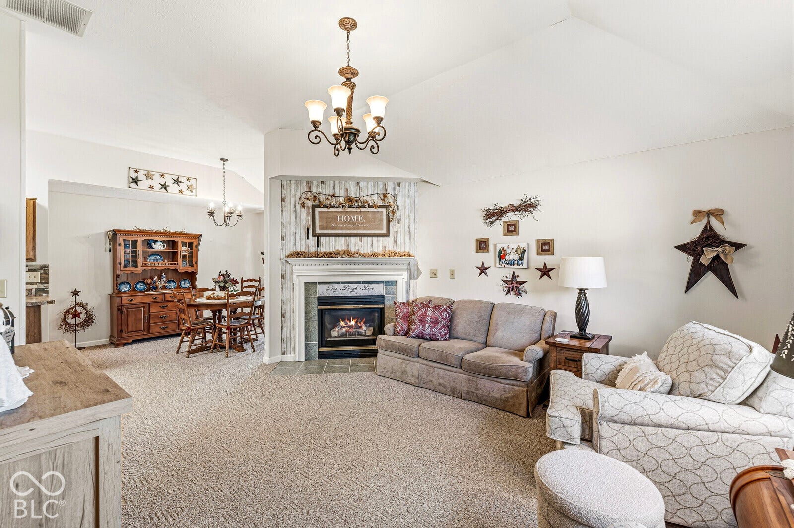 Spacious living room with plenty of natural light, vaulted ceiling, and gas fireplace