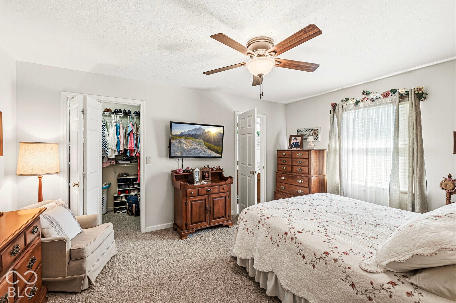 Primary bedroom approximately 15 x 12, carpet, ceiling fan, walk-in closet, and primary bathroom