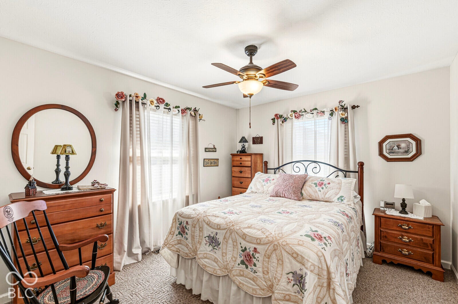 Bedroom 2 - approximately 12 x 11, carpeted flooring, ceiling fan/light, closet, and two windows.