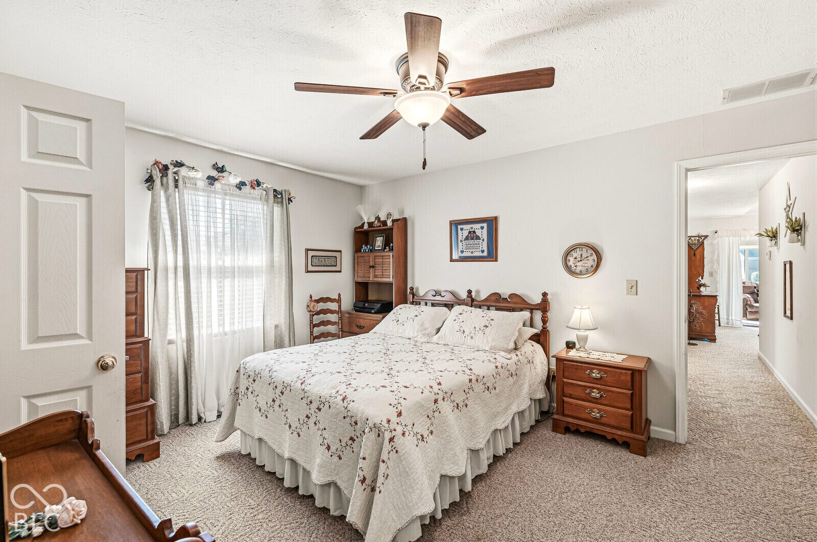 The primary bedroom is located at the end of the hallway. Spacious room.