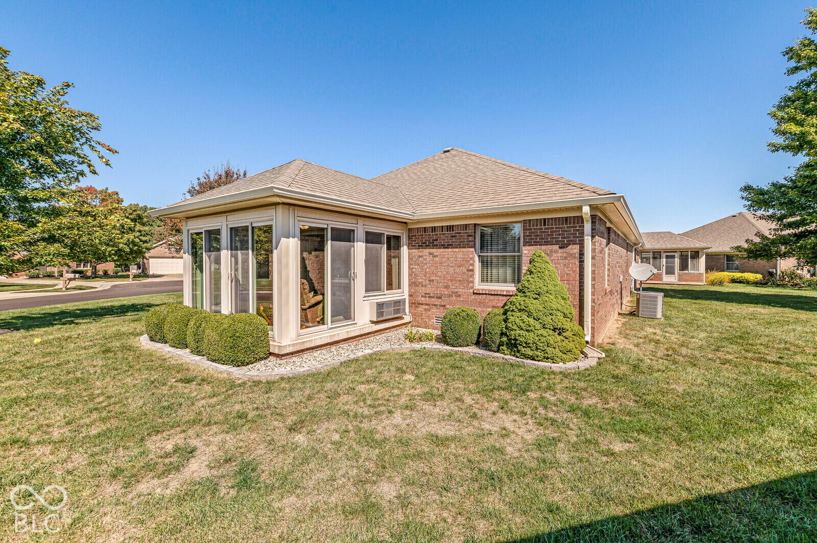 Brick exterior displaying the sunroom addition. Updated landscape with rock for easy maintenance.