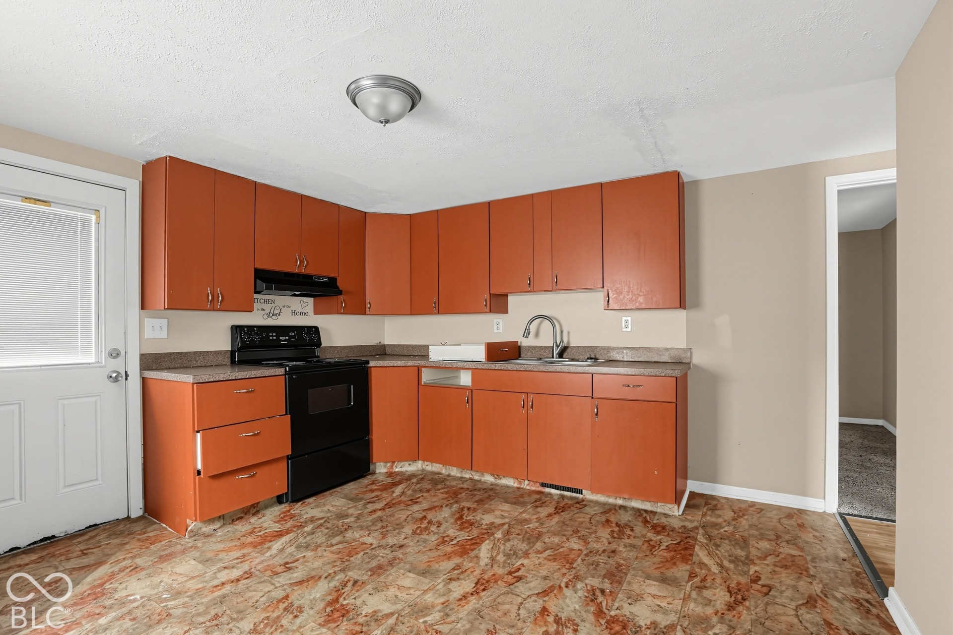 3128 S Rural Street, Indianapolis, IN 46237 Kitchen featuring ample cabinetry, integrated sink, and durable flooring