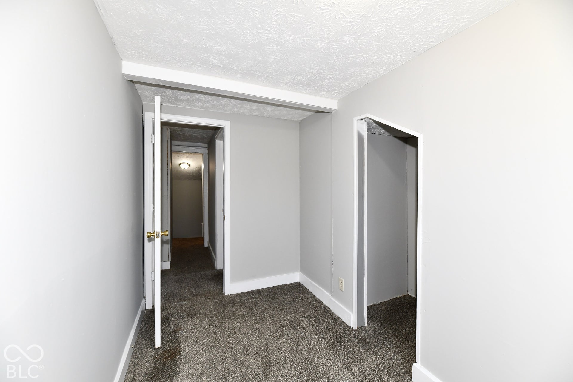 Wall-to-wall carpeting and neutral gray walls