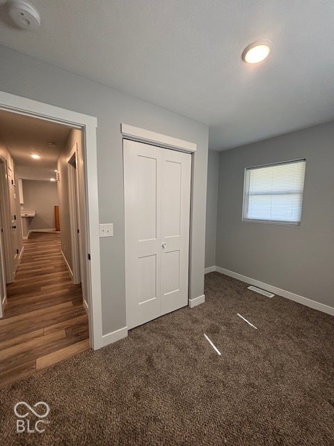 252 Indiana Street, Plainfield, IN 46168 Plush carpeting, recessed ceiling lighting, a window with blinds, and white bi-fold closet doors