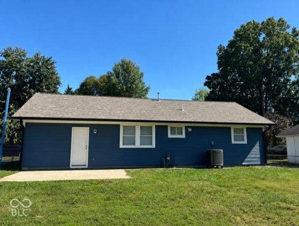 252 Indiana Street, Plainfield, IN 46168 Rear exterior featuring blue siding, white trim, a concrete patio, and a composite shingle roof