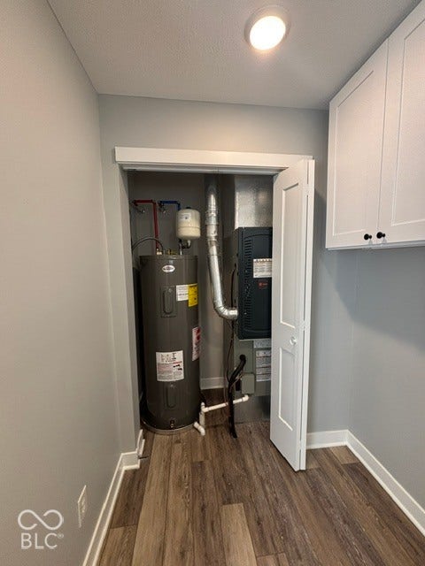 252 Indiana Street, Plainfield, IN 46168 Wood-finish flooring, recessed ceiling lighting, light gray wall paint, and white upper cabinetry with black hardware