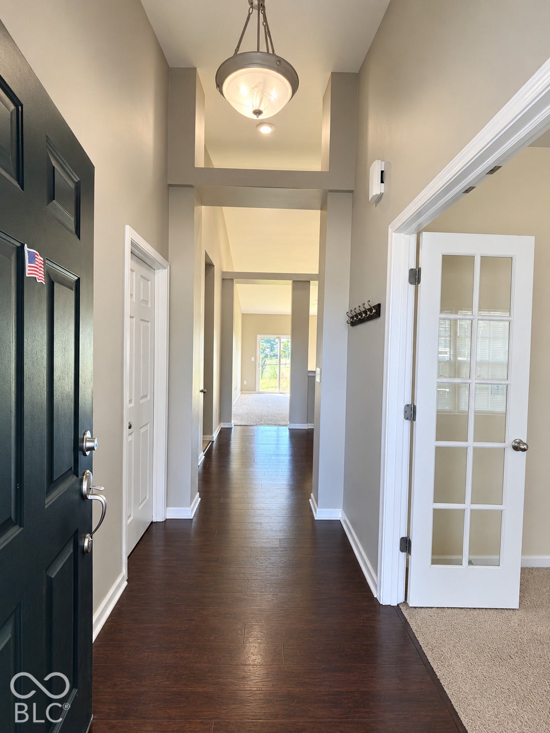 4348 Big Leaf Lane, Indianapolis, IN 46239 Entryway featuring wood-finish flooring, a decorative pendant light, and a white French door