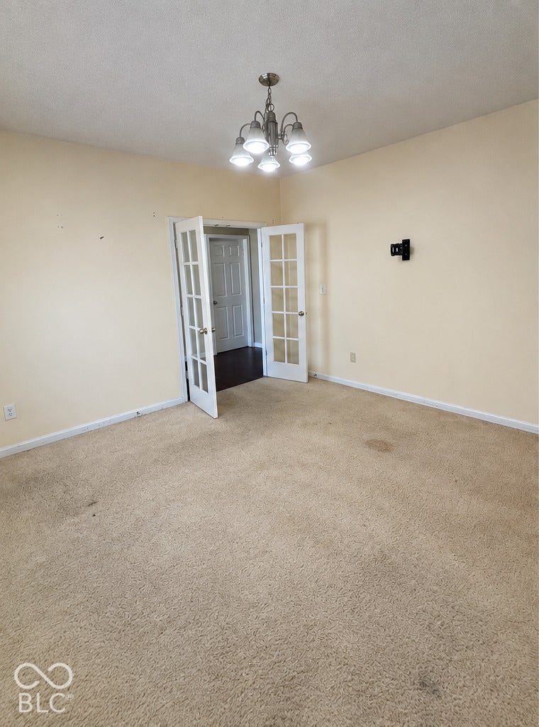 4348 Big Leaf Lane, Indianapolis, IN 46239 French Doors lead to 1st room by entrance, chandelier and natural sunlight illuminate the room