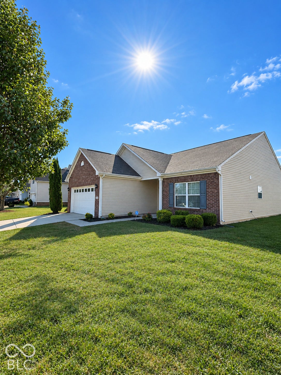 4348 Big Leaf Lane, Indianapolis, IN 46239 Brick and siding exterior with a pitched roof, front entry garage, and manicured front lawn